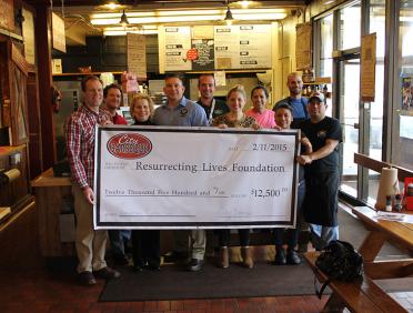 City Barbeque teammates with donation check