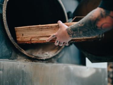 City Barbeque pitmaster loading smoker